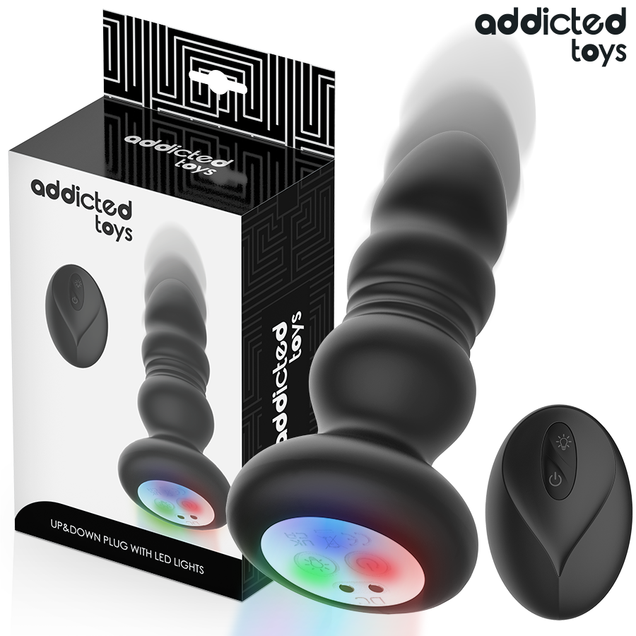 Plug anal va-et-vient Addicted Toys devant sa boîte, base LED allumée et télécommande